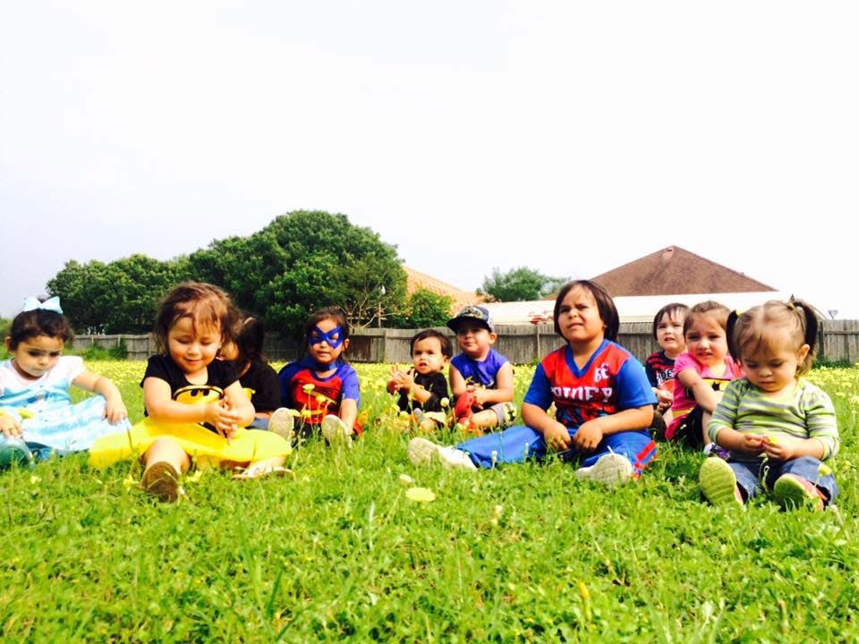 Group of children sitting on grass outdoors