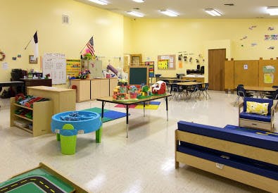 Classroom with tables, chairs, and various toys