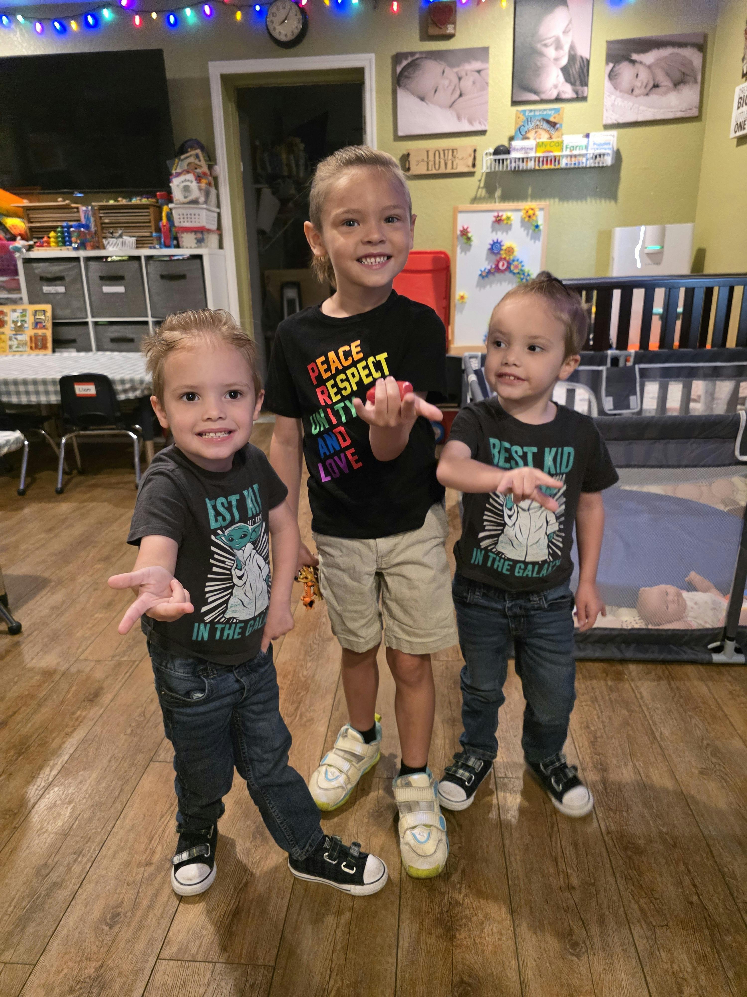 Three children standing and smiling