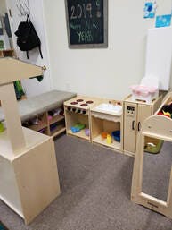 Play kitchen and other wooden furniture in a classroom