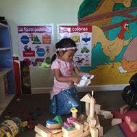 Child playing with blocks in a room
