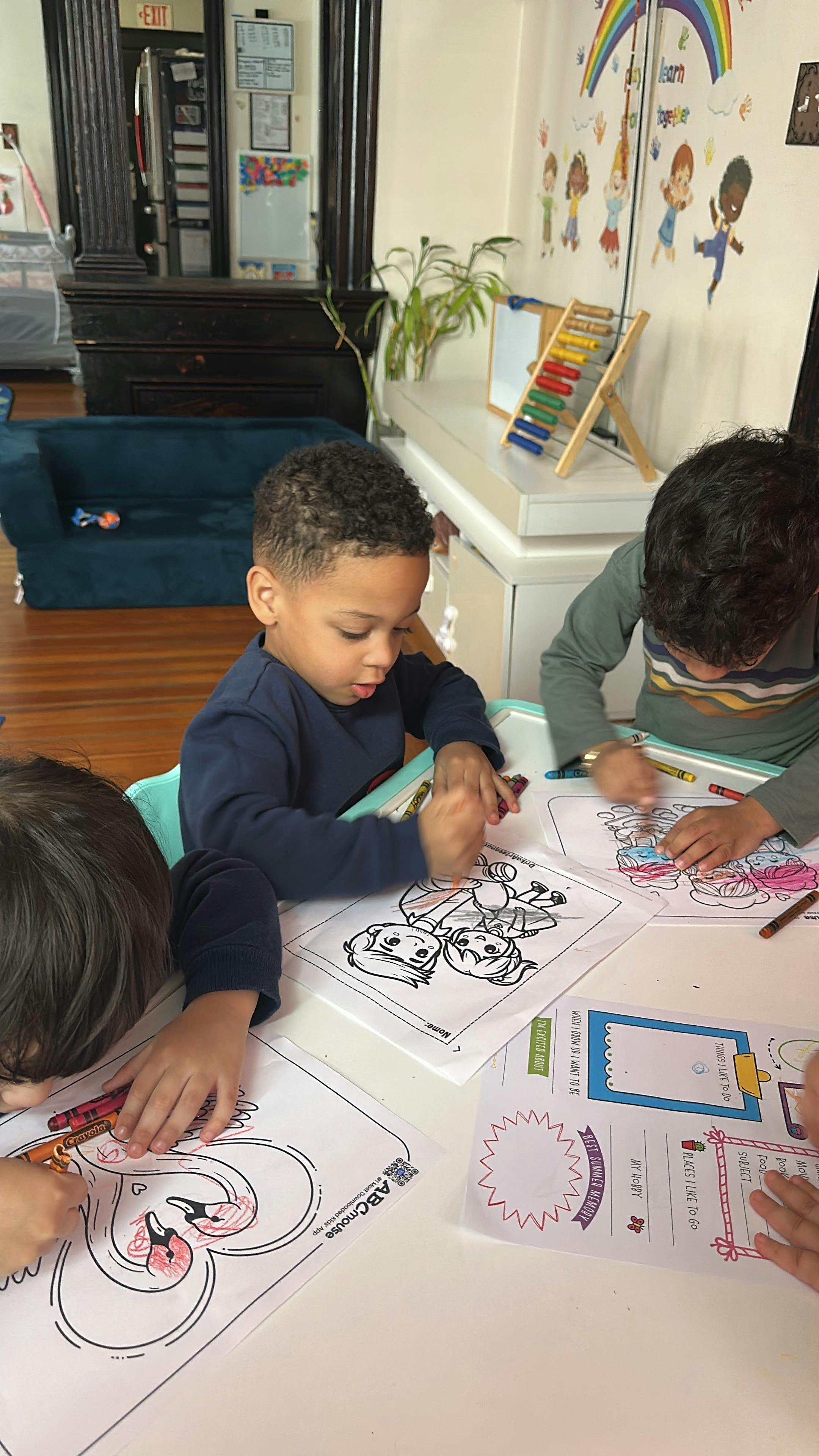 People coloring on activity sheets at a table