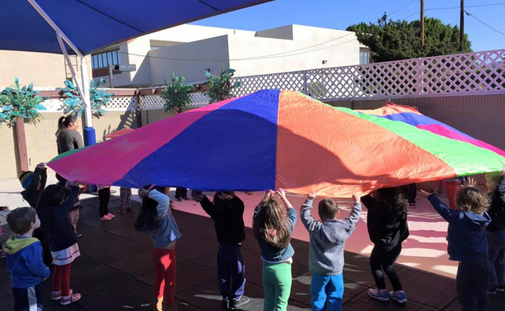 Children holding up a colorful parachute