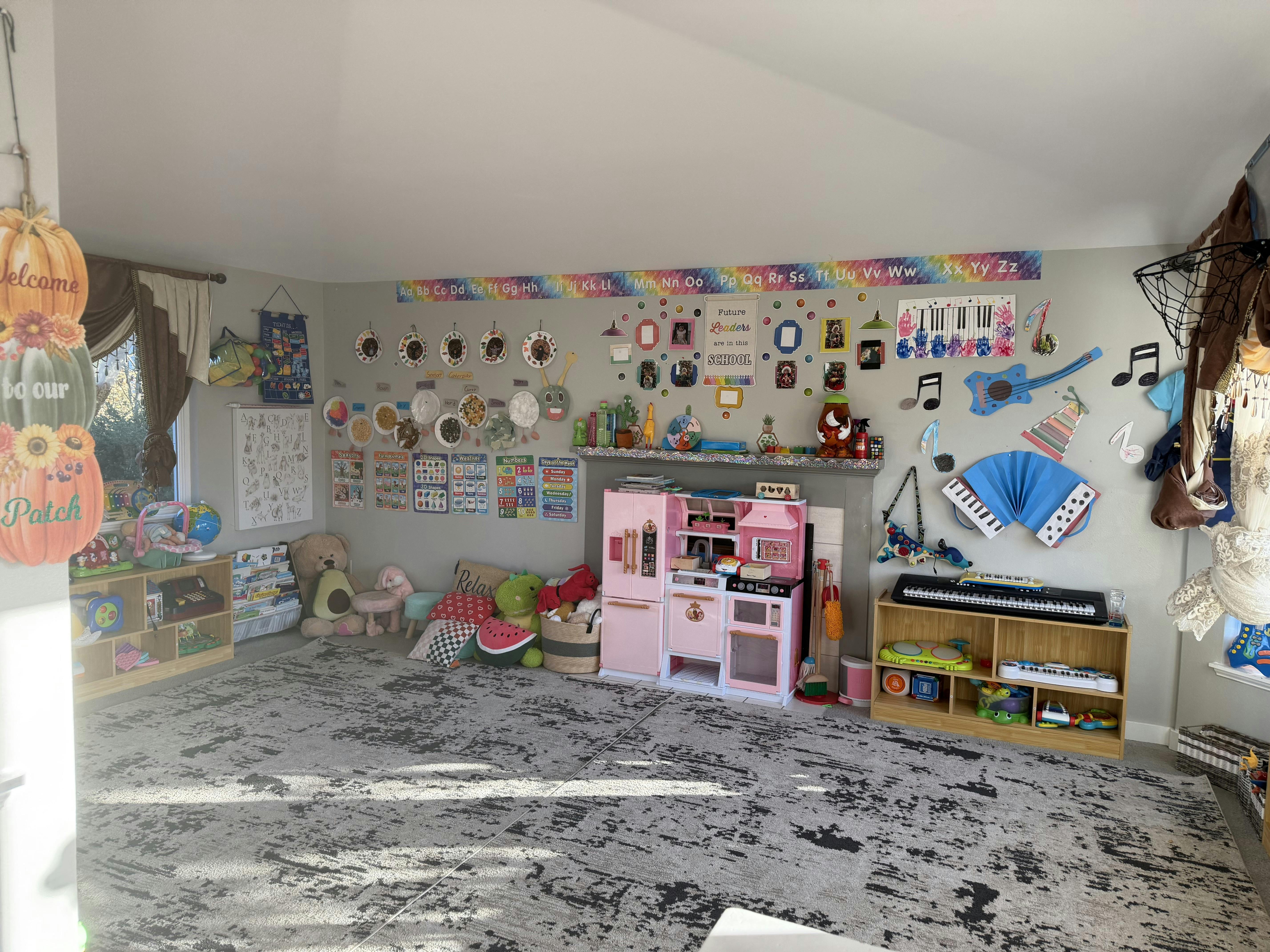 Colorful playroom with shelves, toy kitchen, and educational wall charts