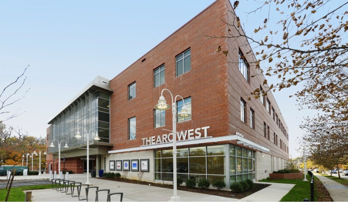 The Arc West building exterior with brick and glass facade