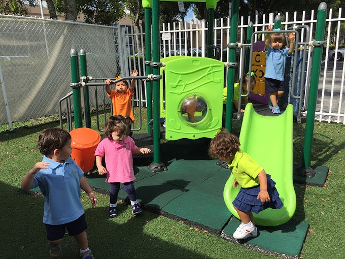 Children playing on a playground structure with a slide