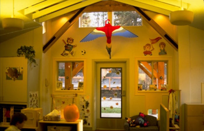 Playroom with a door, windows, and a bird decoration above