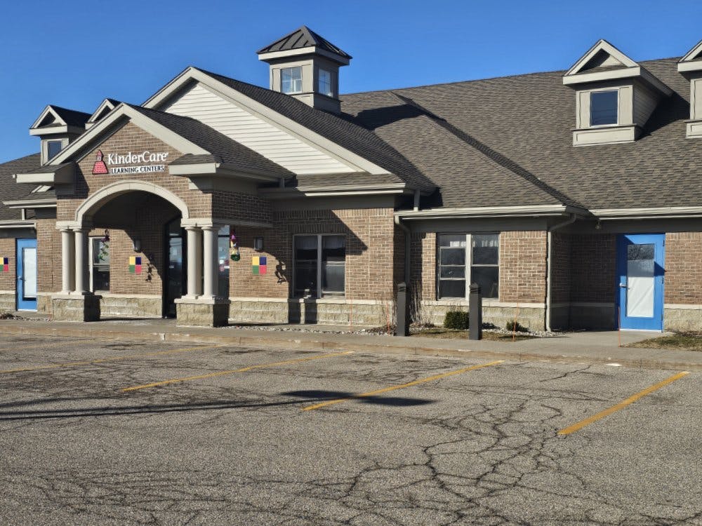 KinderCare Learning Centers building exterior with blue doors and parking lot