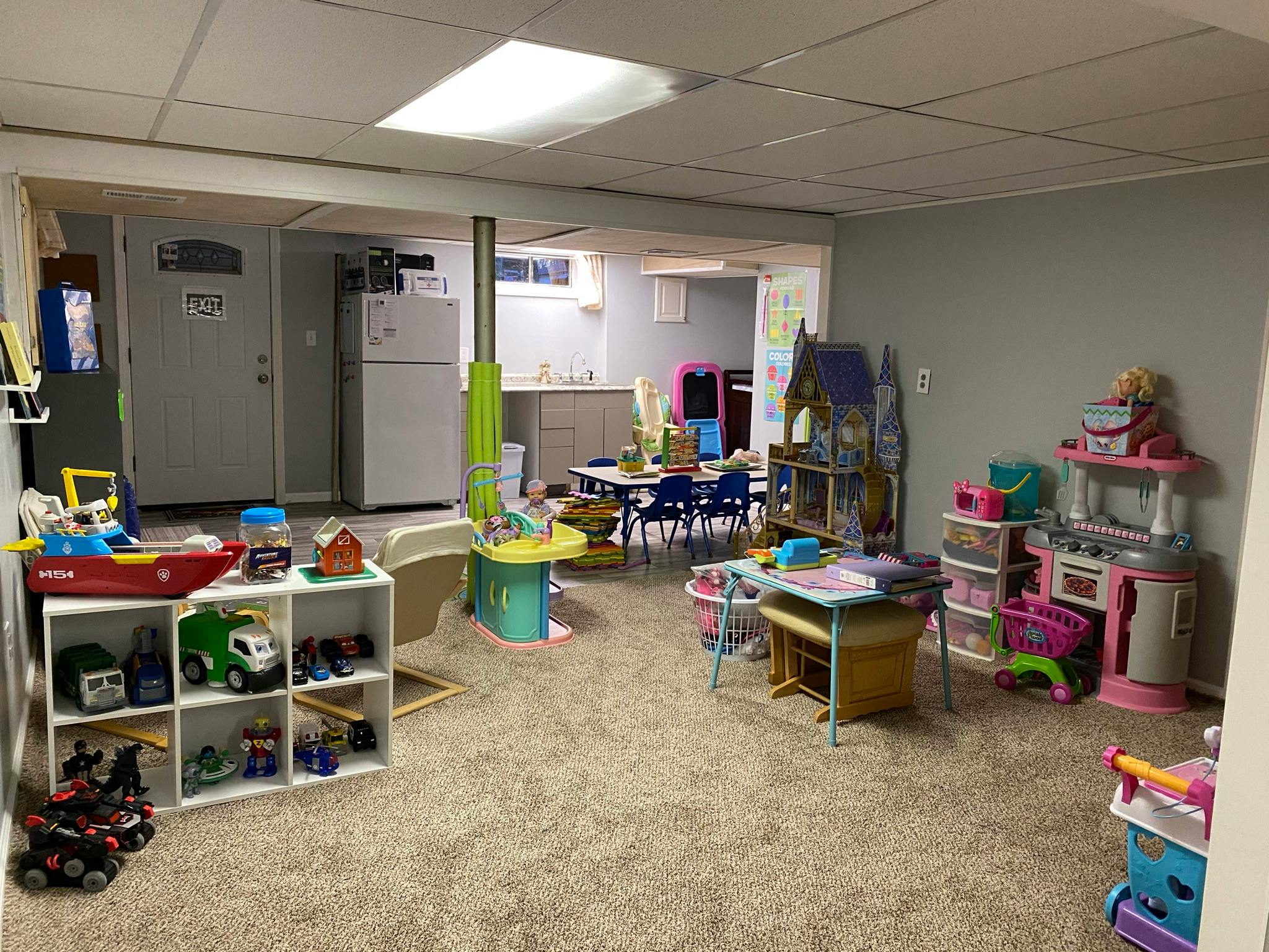Playroom with toys, tables, and chairs