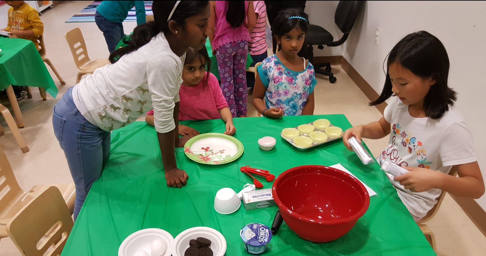 Children at a table with baking ingredients