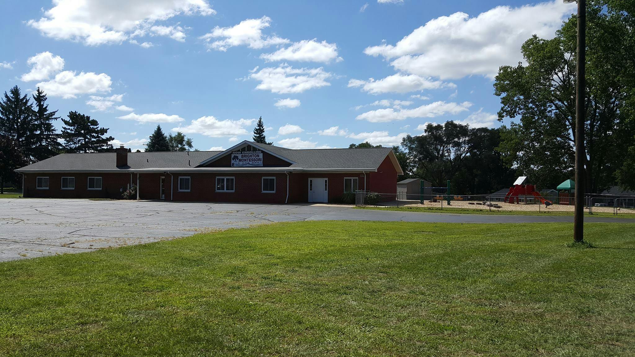Building with a parking lot and grassy area