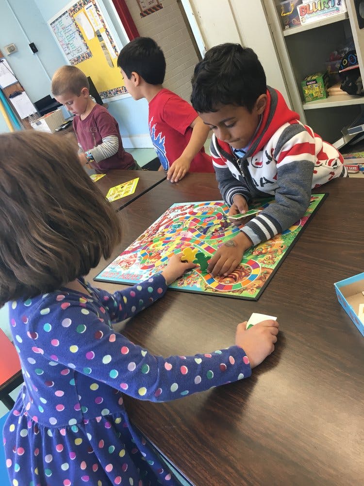 Children playing a board game at a table