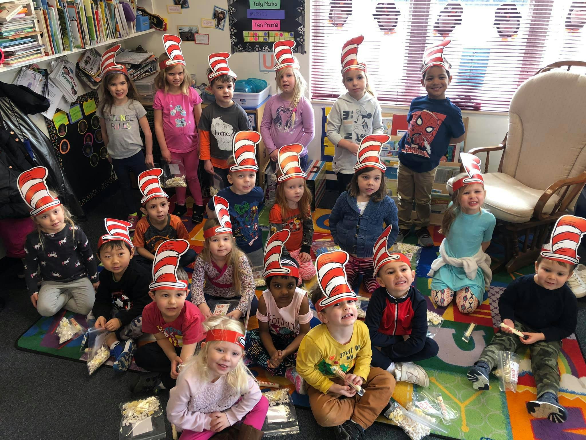 Group of children wearing red and white striped hats