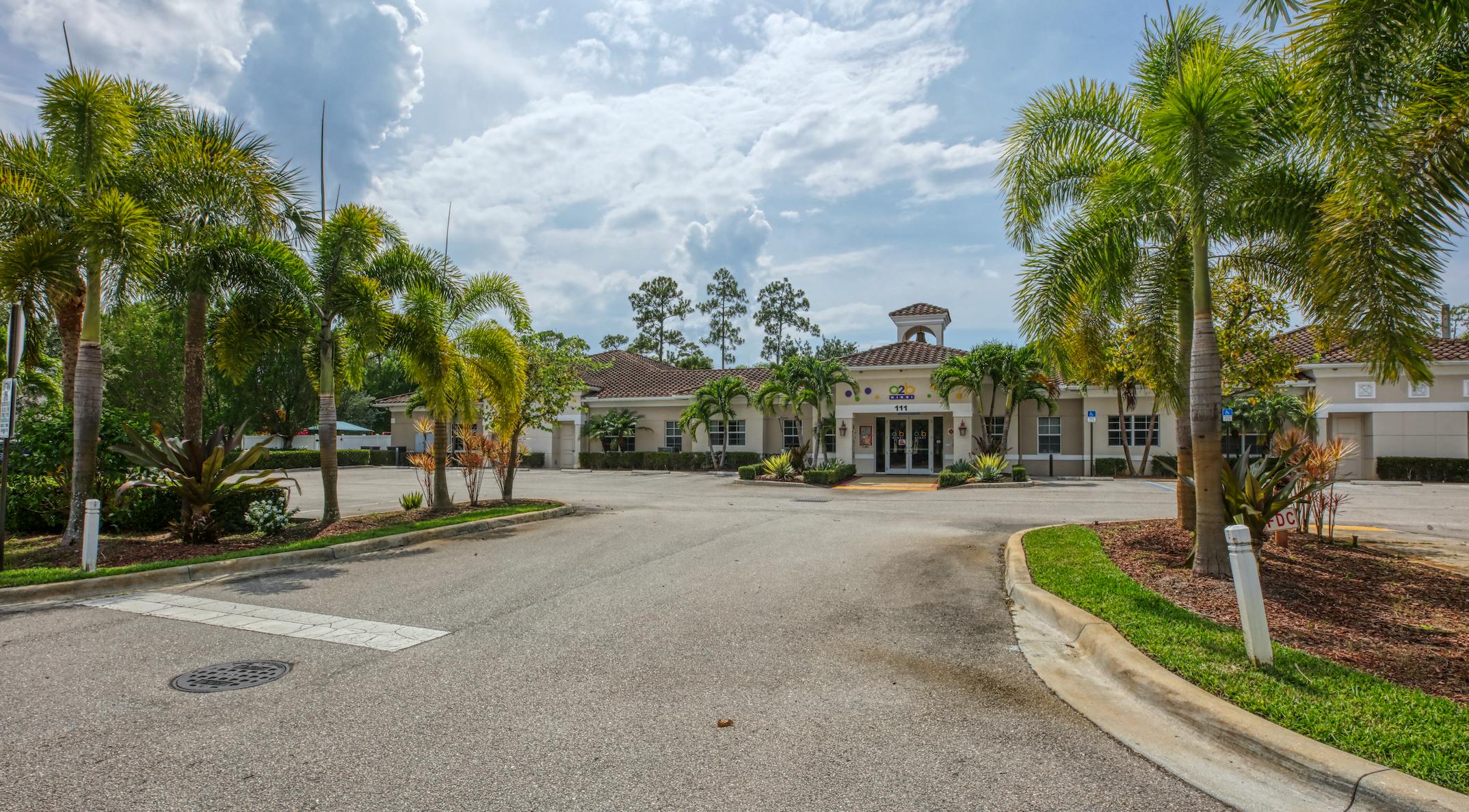 Building with 111 on the facade and palm trees in front