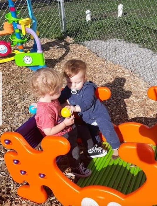 Two children playing on a seesaw