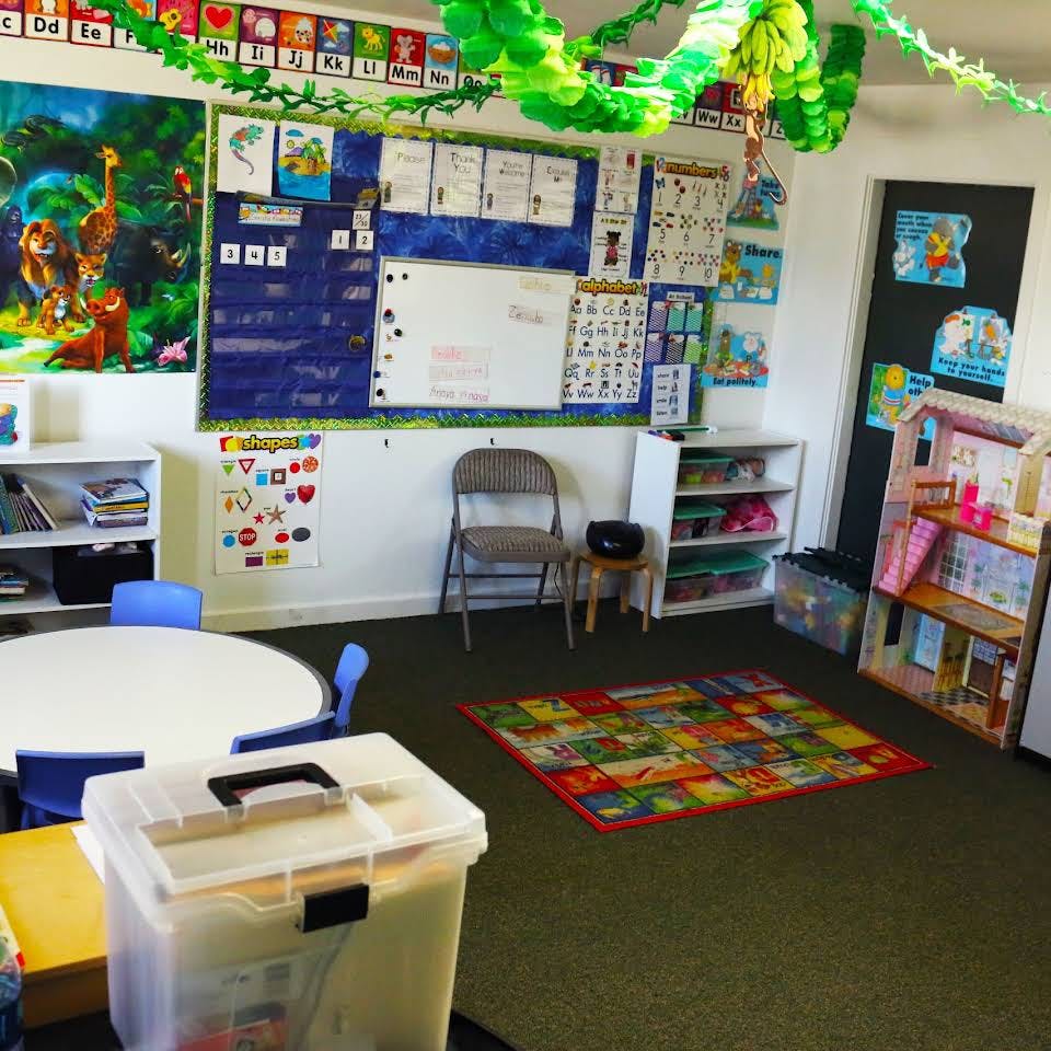 Classroom with colorful decorations, bulletin boards, and small tables