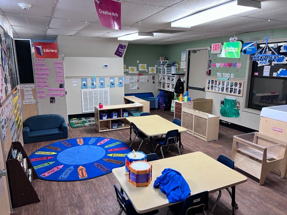 Empty colorful children's classroom with small tables and chairs