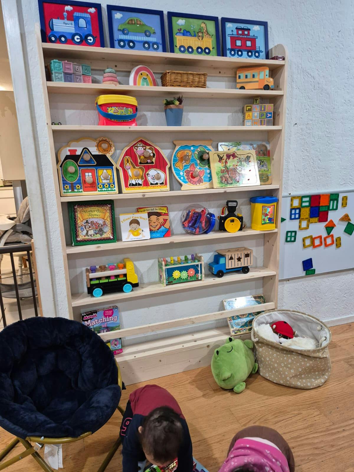 Wooden shelf filled with children's toys and books