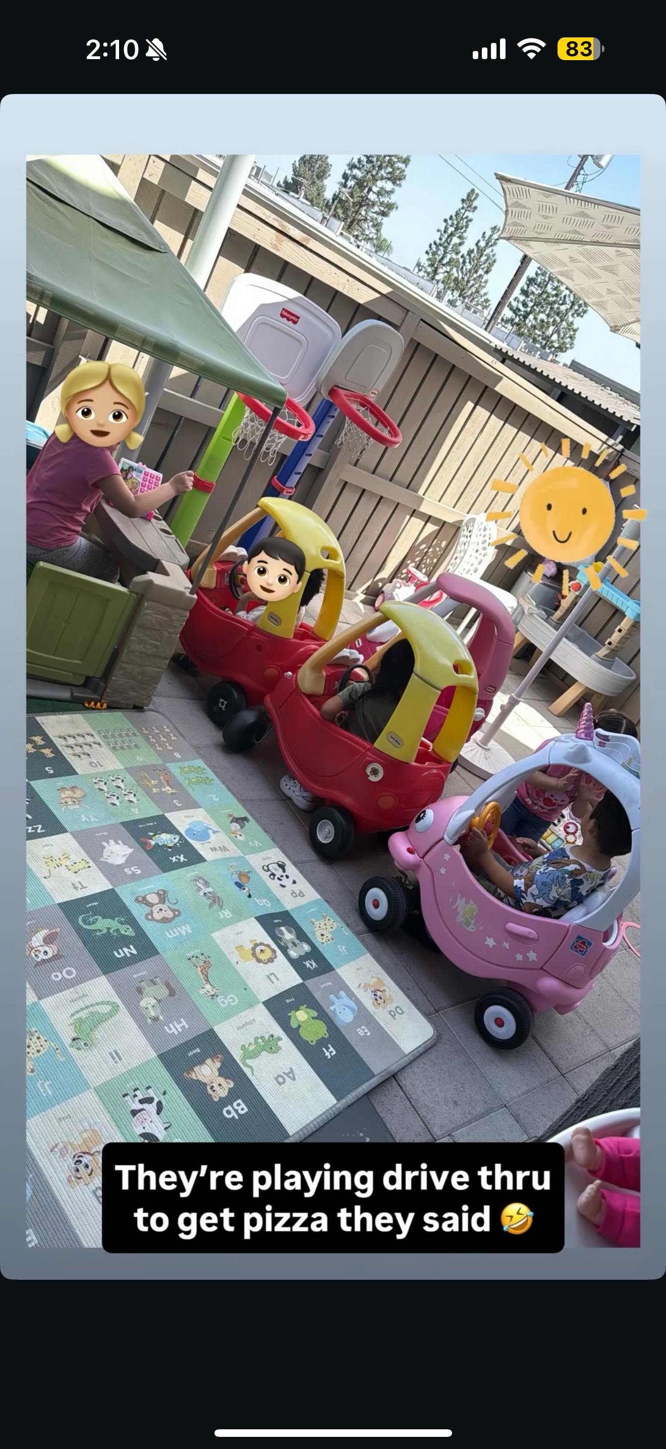 Child playing in a toy car with another child at a table