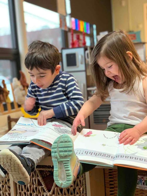 Two children looking at open books