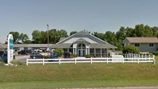 Building with a white fence in front