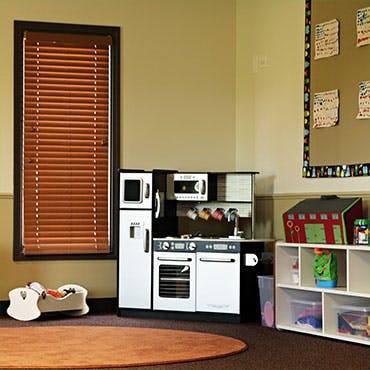 Toy kitchen set in a room with a window and shelves