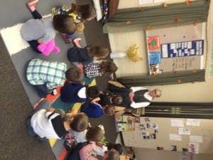 Adult reading to children in a classroom
