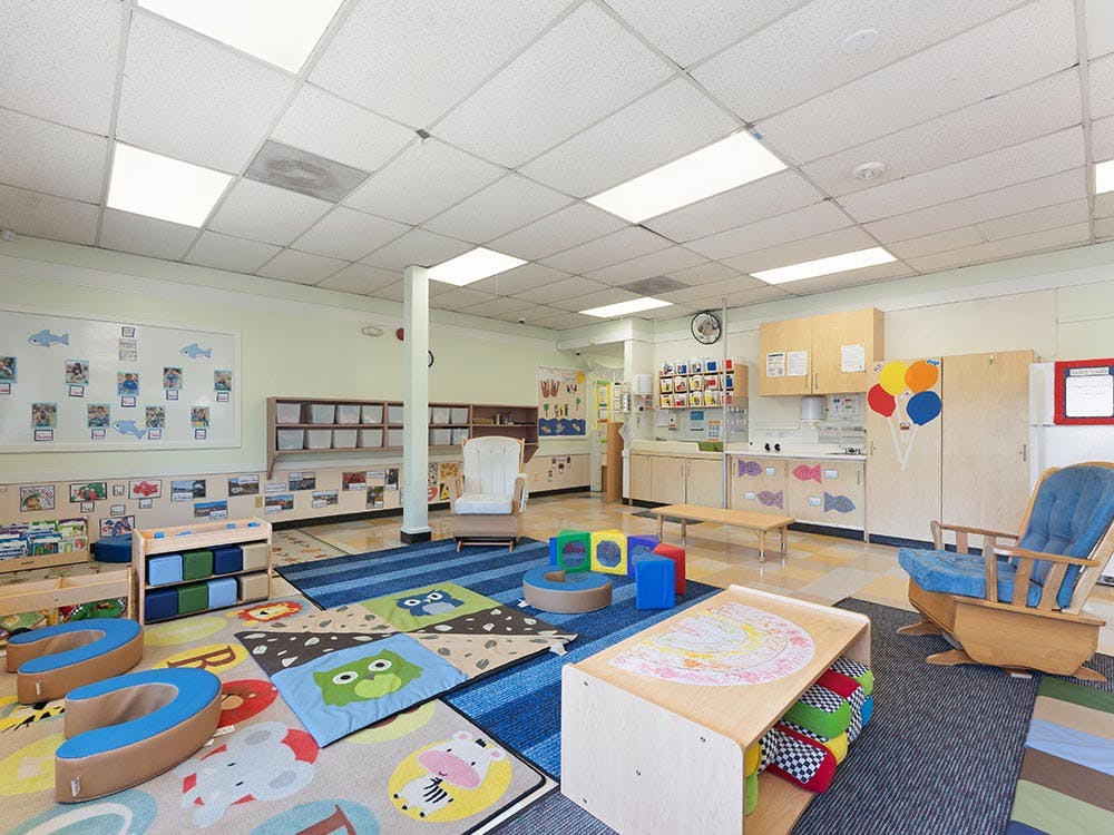 Colorful classroom with child-sized furniture and play mats