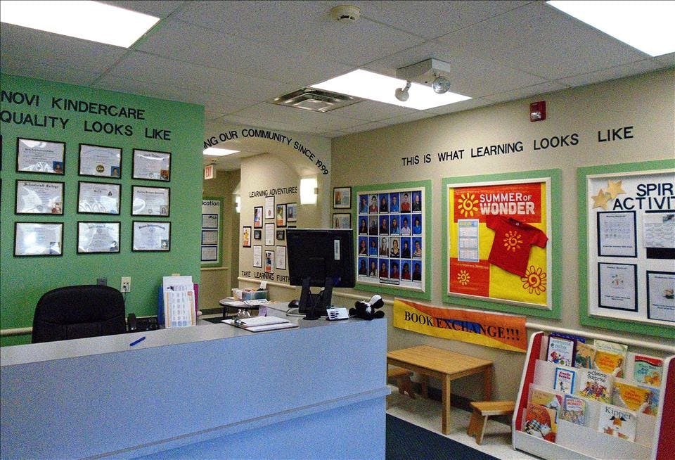 Reception area of a learning center with bulletin boards, diplomas, and a book exchange