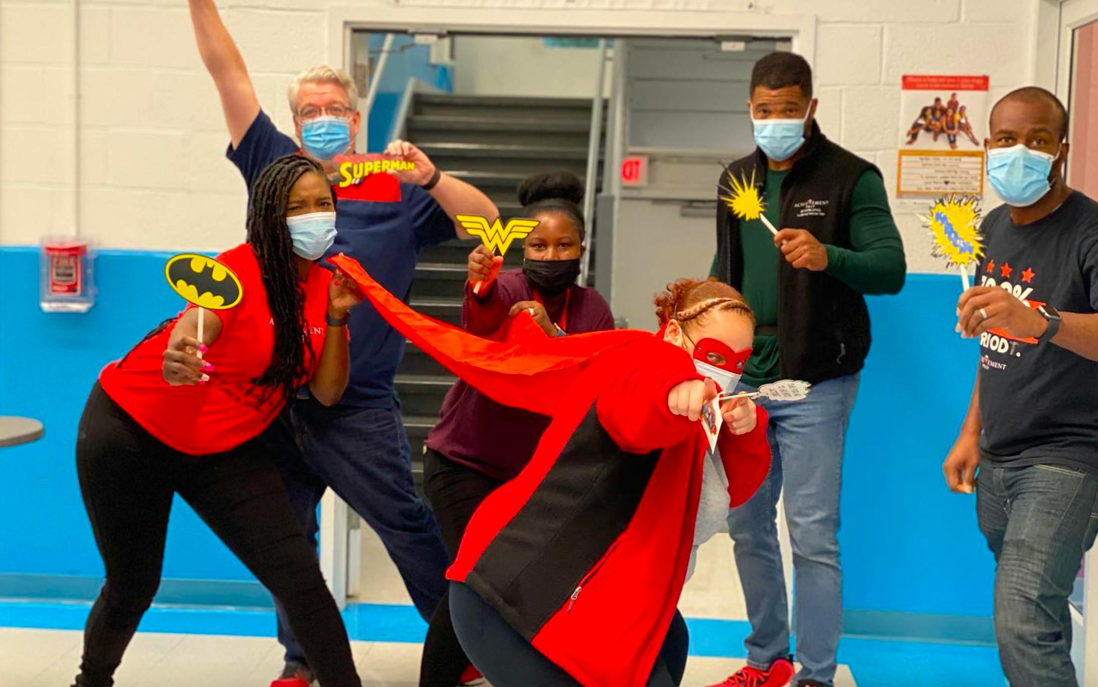 Group of people in superhero costumes and masks posing