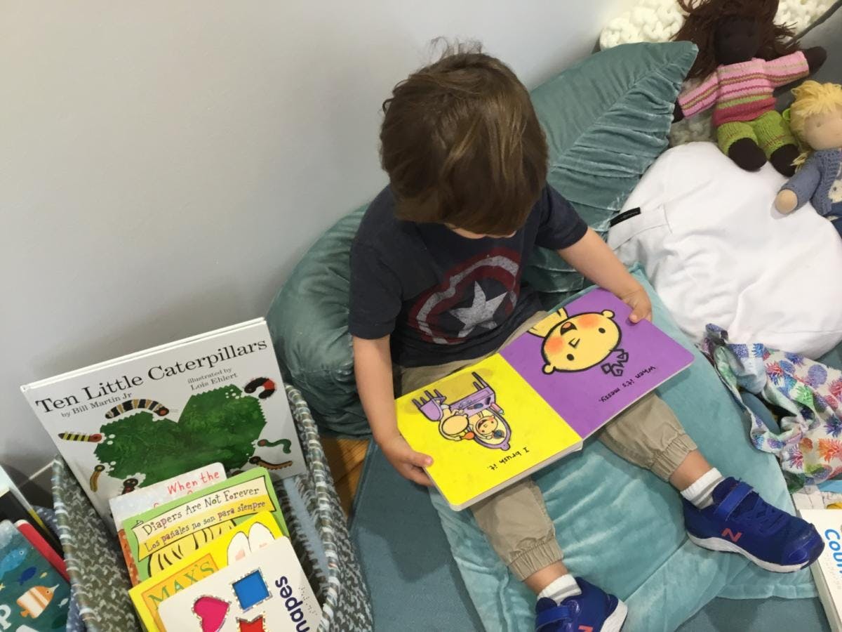Child sitting and reading a book