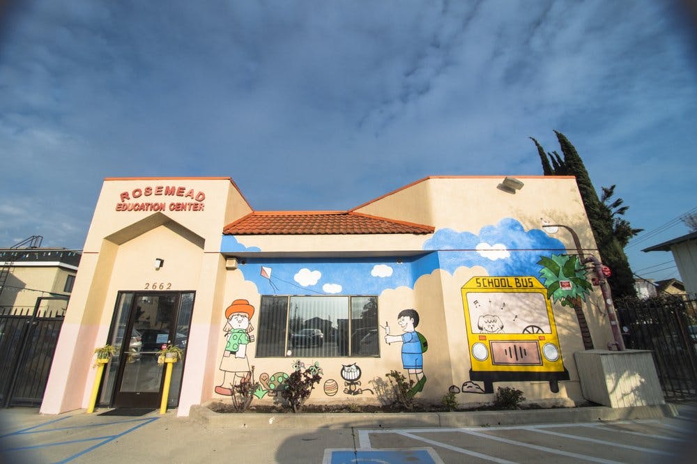 Building with "Rosemead Education Centre" sign and child-like murals