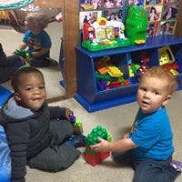 Two children playing with toys on the floor