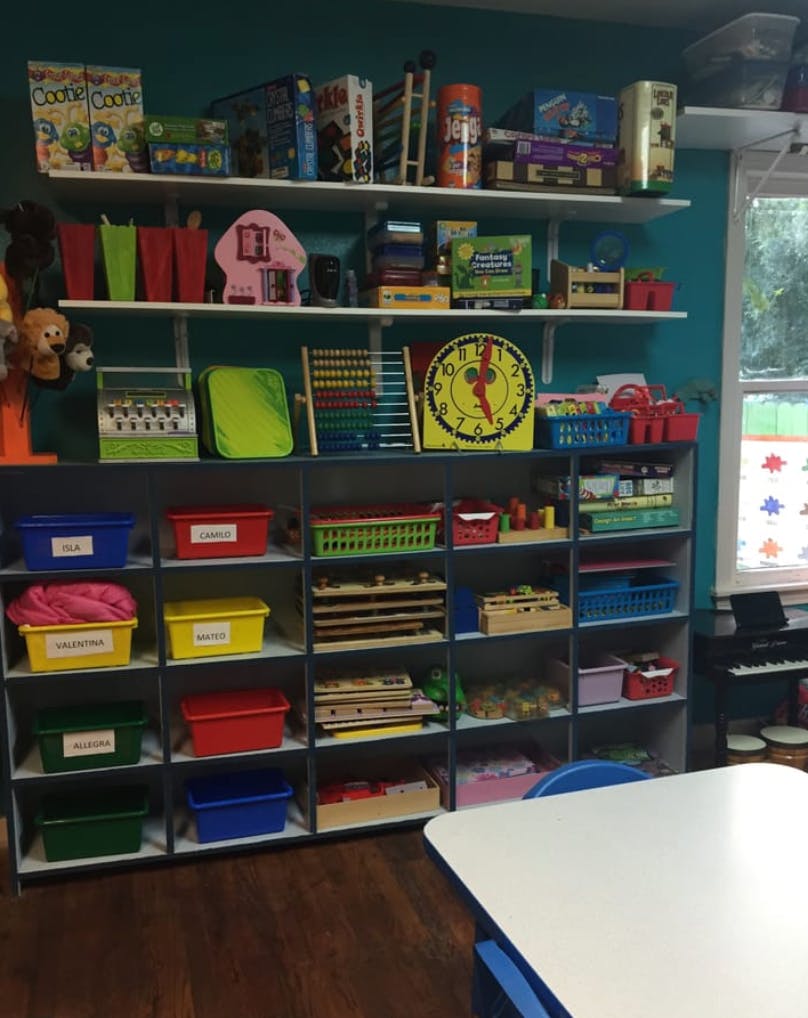 Shelves filled with various educational toys and supplies in a classroom