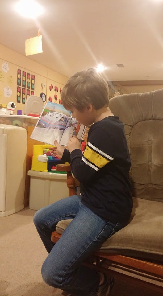 Child sitting and reading a book