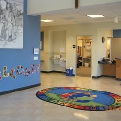 Welcome area with a colorful rug and a blue wall