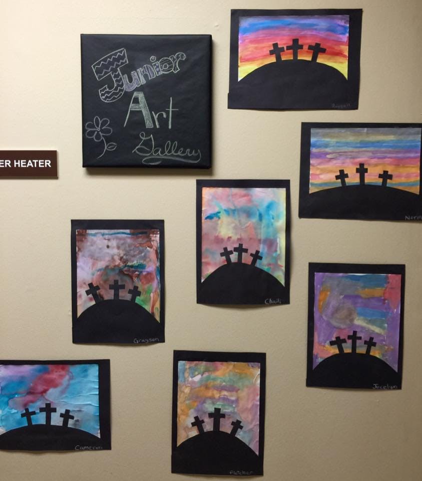 Children's artwork of crosses on hills with colorful backgrounds