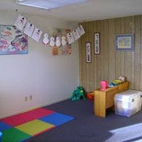 Playroom with colorful floor mats and children's artwork