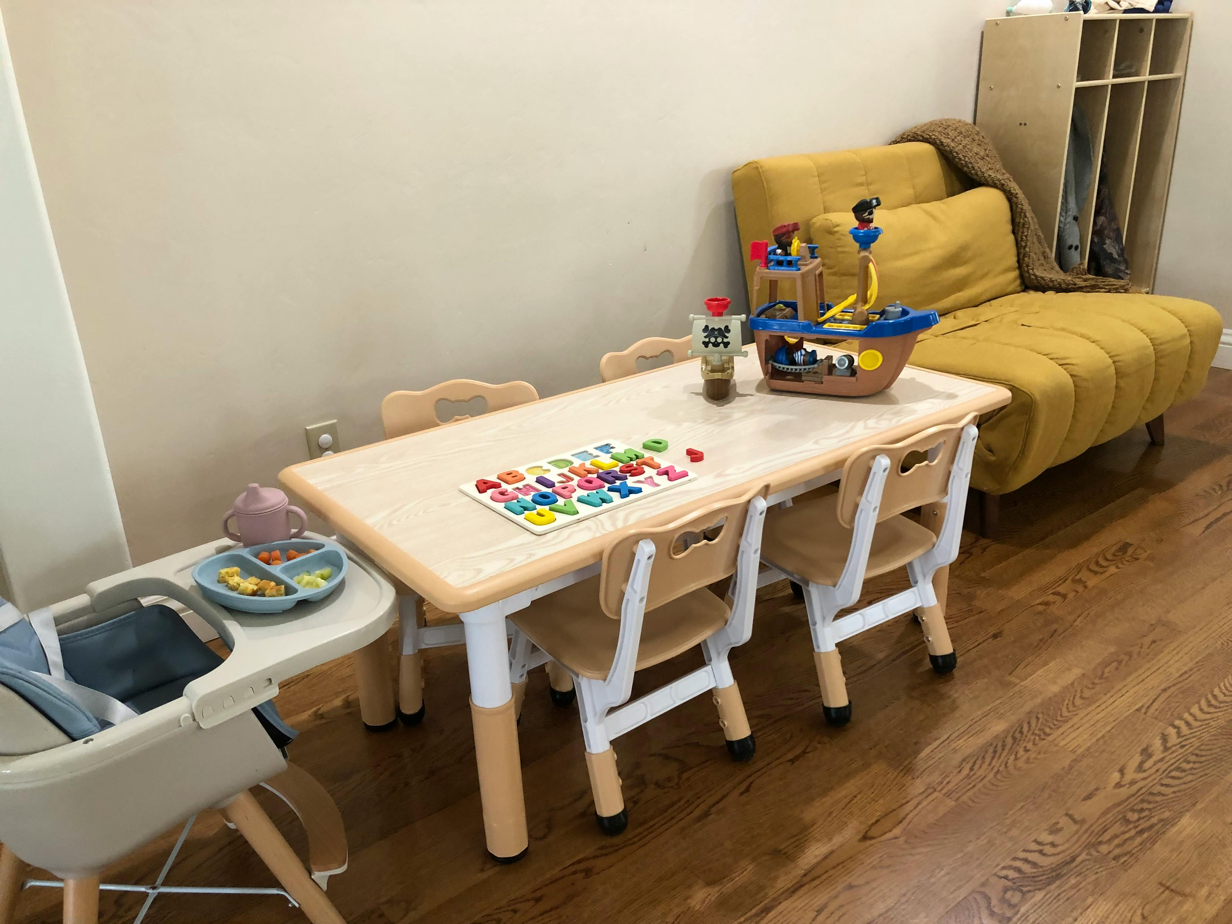 Children's table and chairs with a high chair next to it