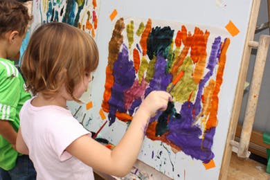 Child painting on an easel