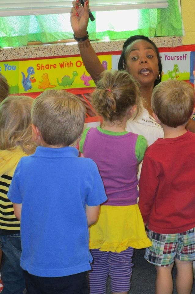 Adult speaking to a group of children