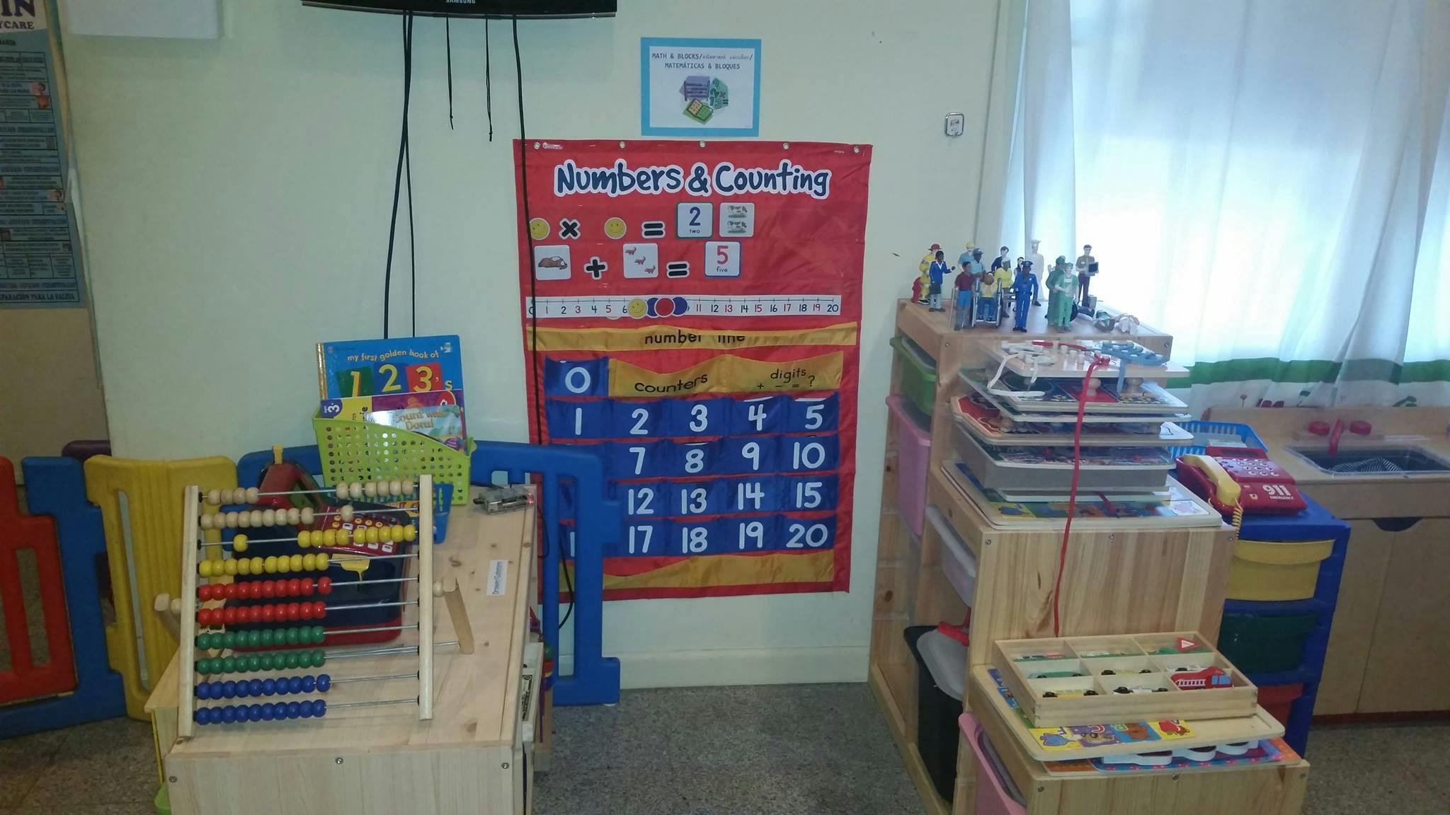 Classroom with abacus, learning charts, and shelves of educational materials