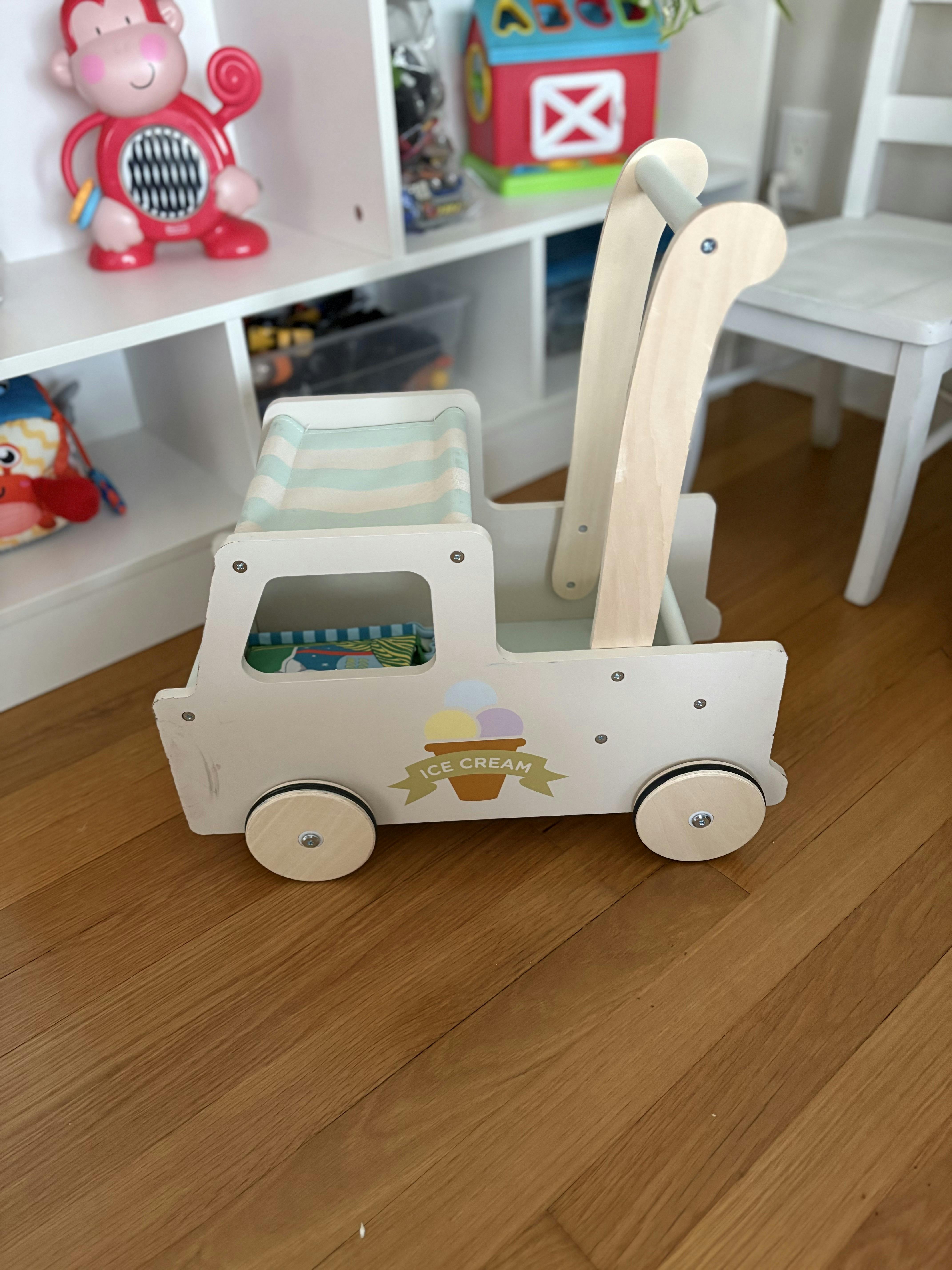 Wooden toy ice cream truck with a striped canopy