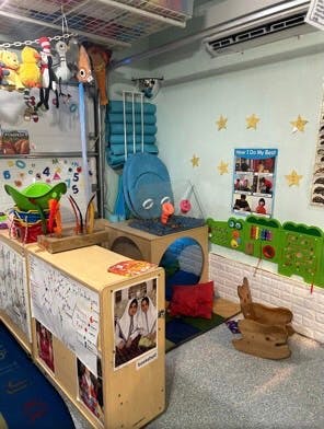 Classroom with play area, toys, and learning materials