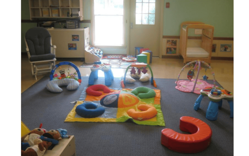 A colorful playroom with various baby toys and furniture