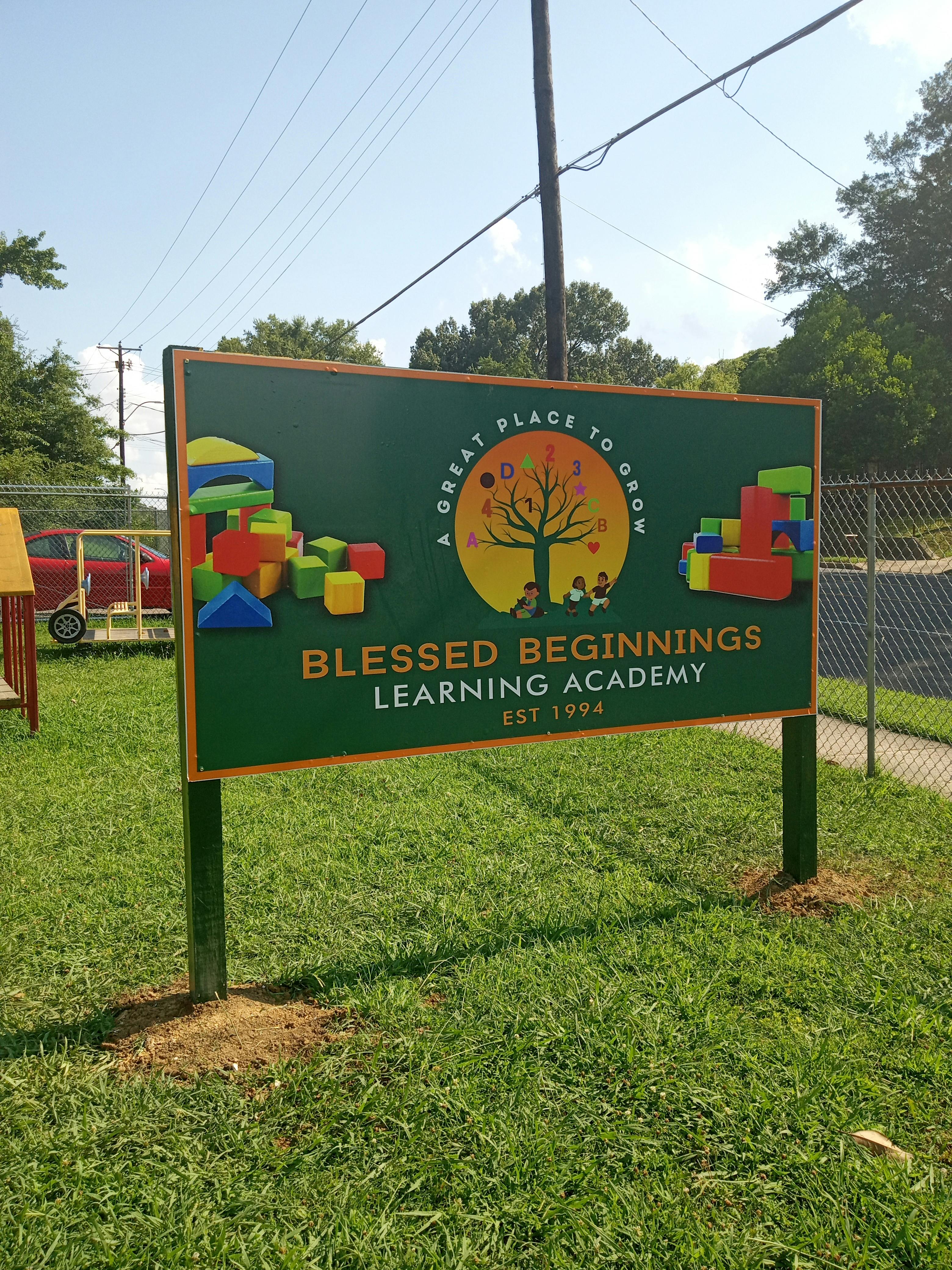 Blessed Beginnings Learning Academy sign with colorful blocks and a tree graphic