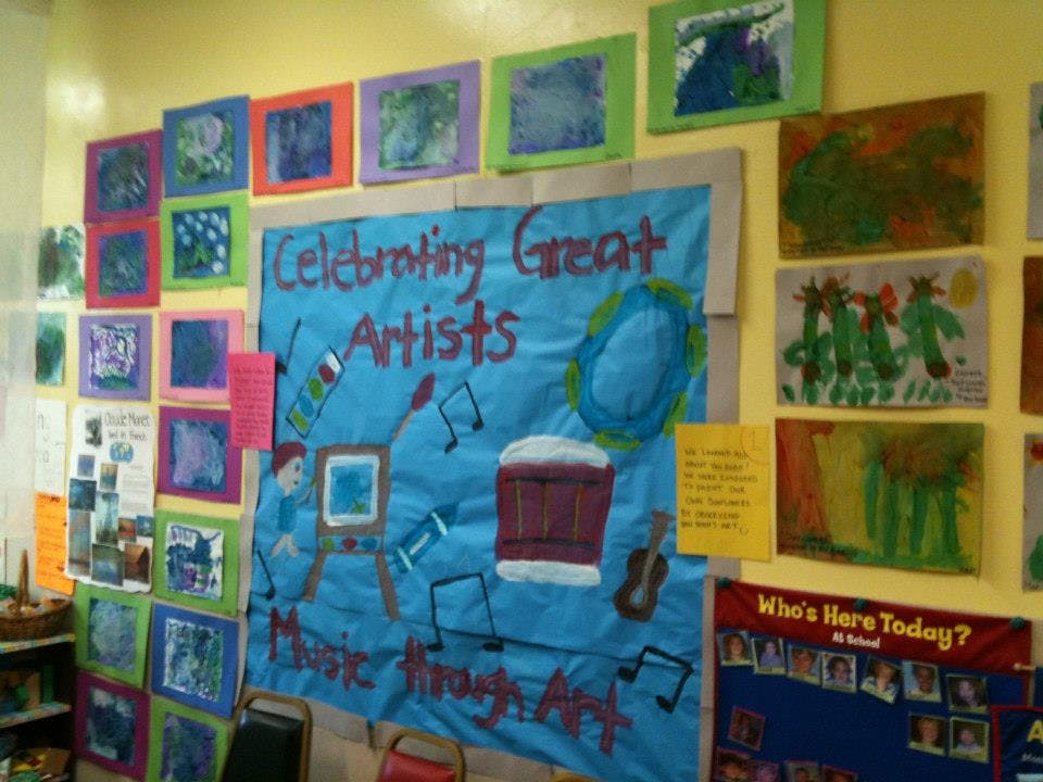 Children's artwork and a banner that reads "Celebrating Great Artists" on a wall