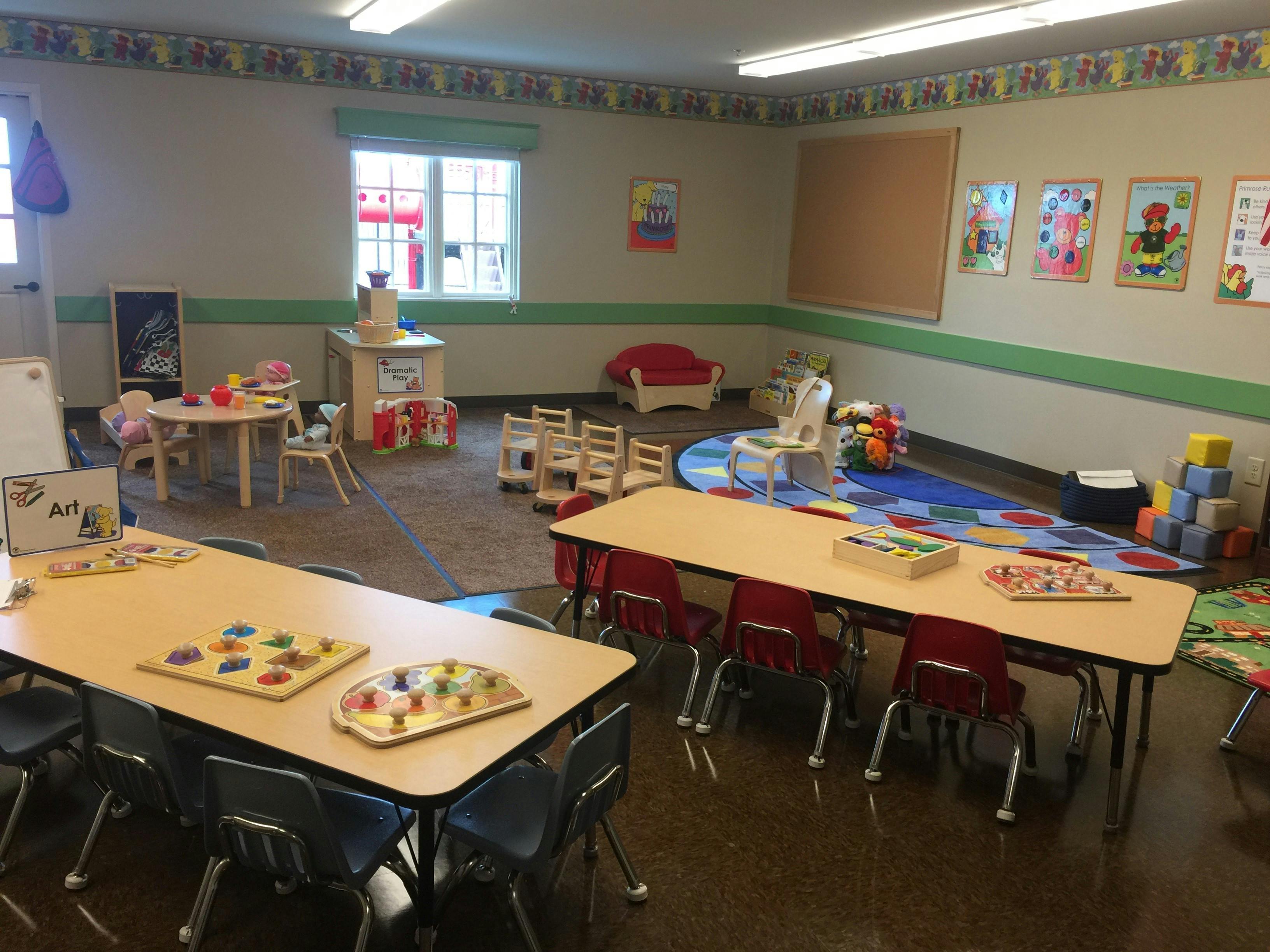 Classroom with tables, chairs, and play areas