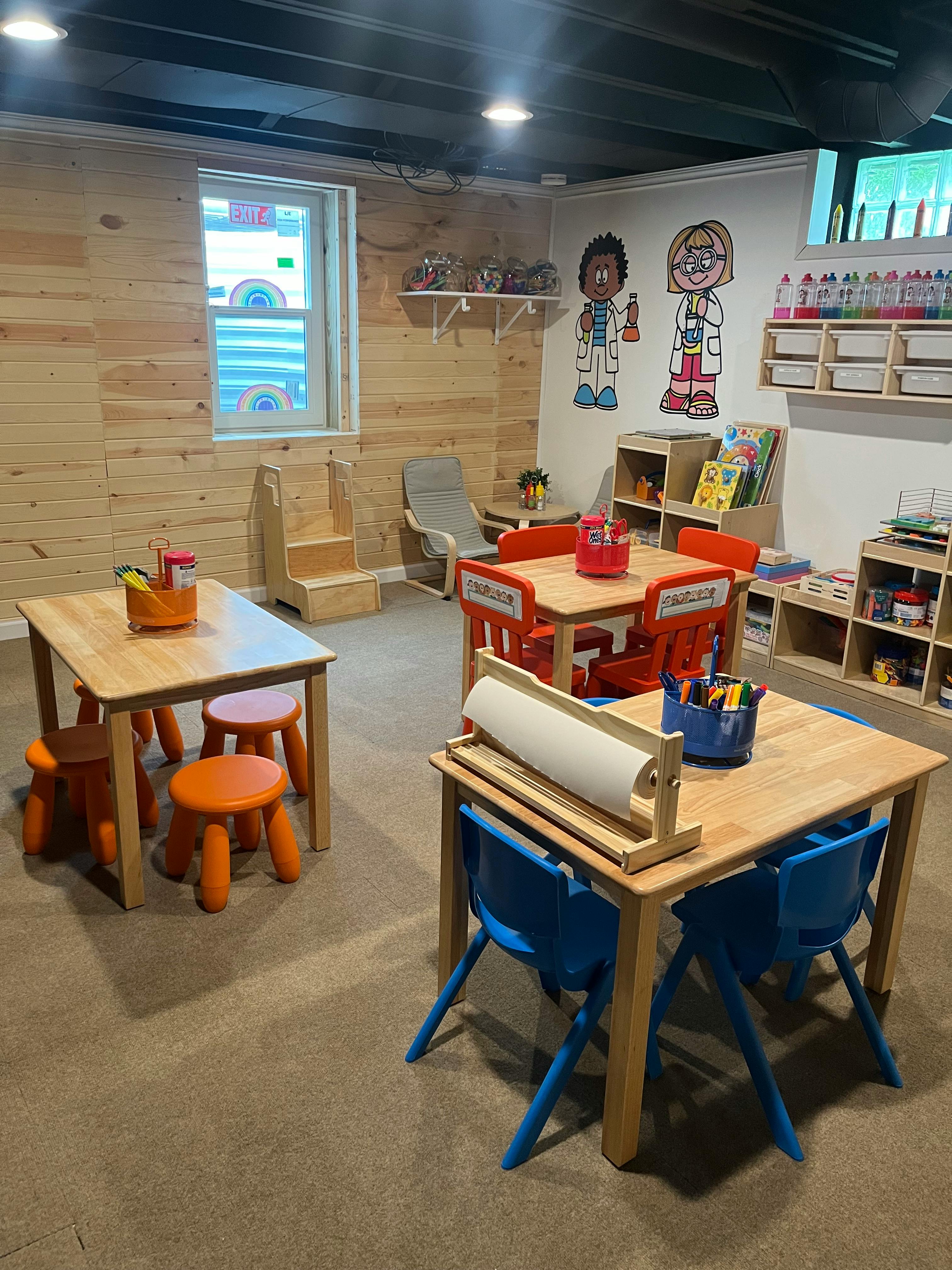 Classroom with small wooden tables and chairs