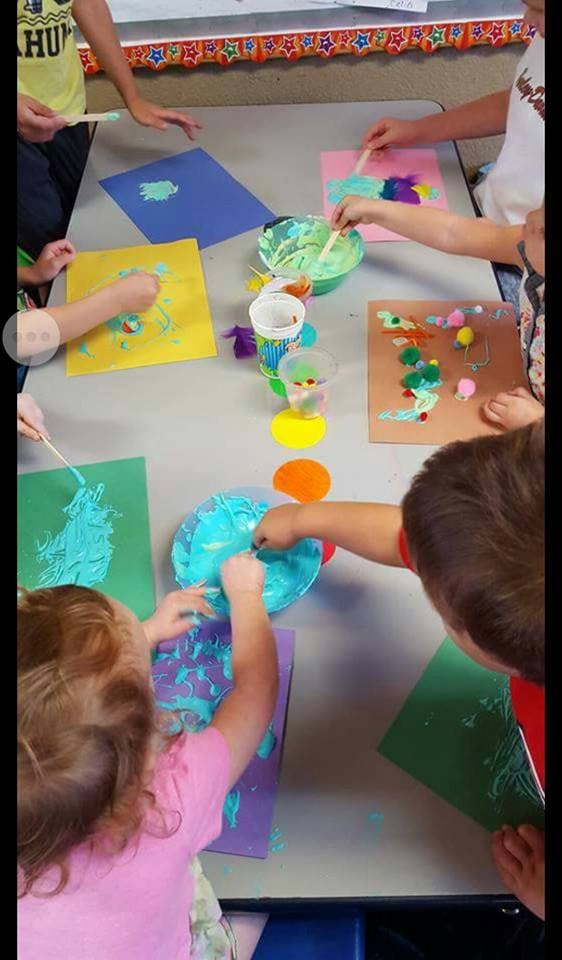 Children painting at a table